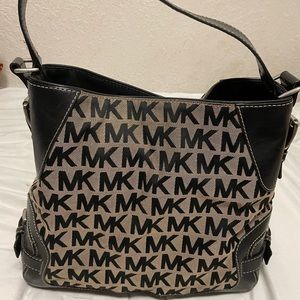 Michael Kors black leather handbag with MK initials all over it